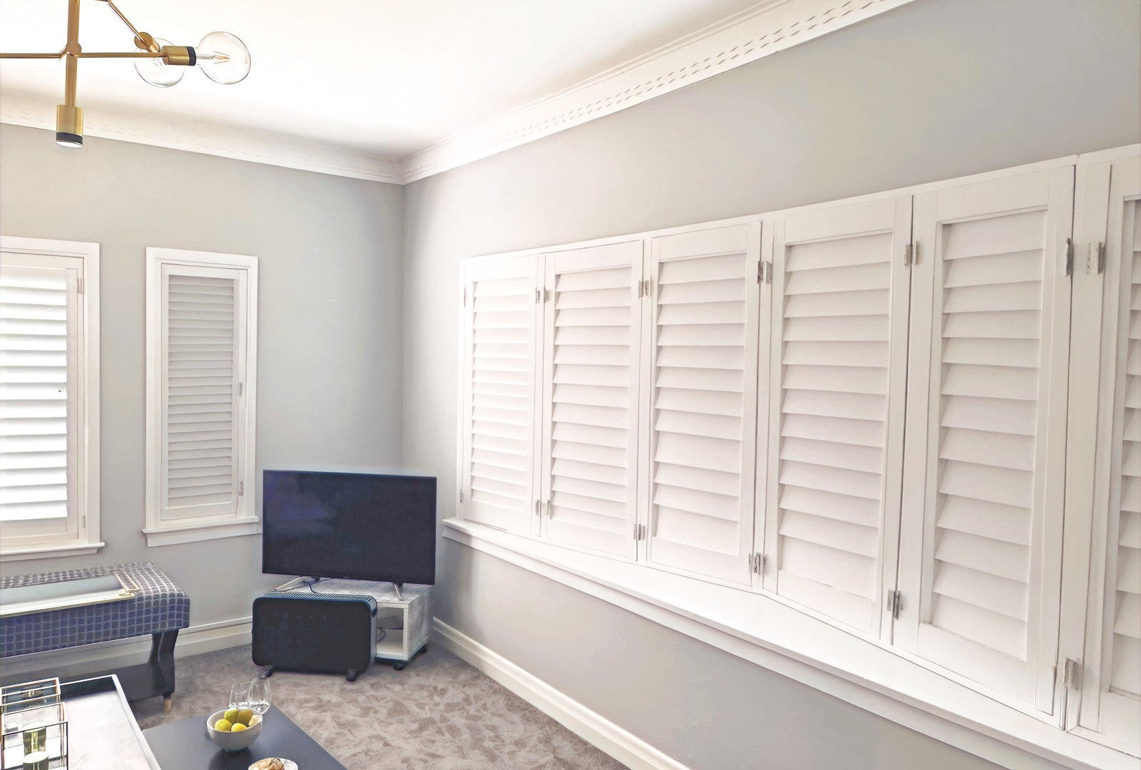 Interior plantation shutters in white finish fitted to a bay window in a Wellington heritage villa